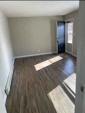 a view of wooden floor and windows in a room