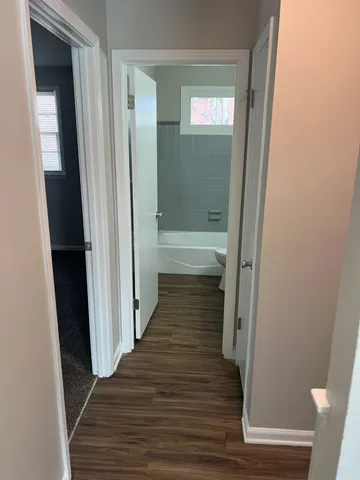 a view of a bathroom from a hallway