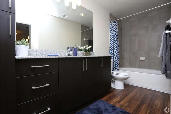 a bathroom with a sink toilet and shower