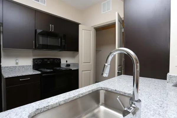 a kitchen with a sink and a microwave