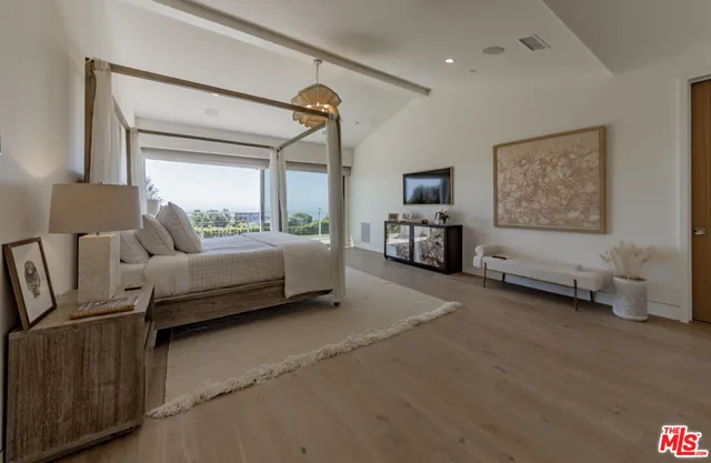 a bedroom with a bed and a couch