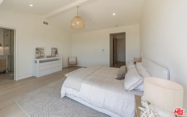 a bedroom with a bed and a couch