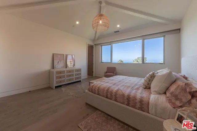 a bedroom with bed and window