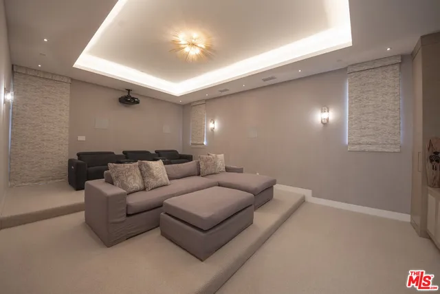 a living room with furniture and a ceiling fan