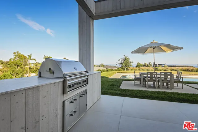 a view of a terrace with chairs and a yard