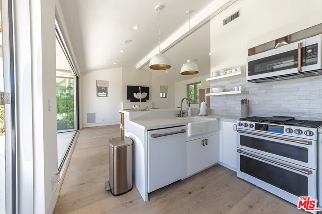 a kitchen with a stove and a sink