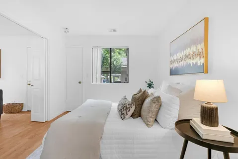 a bedroom with a bed and a lamp