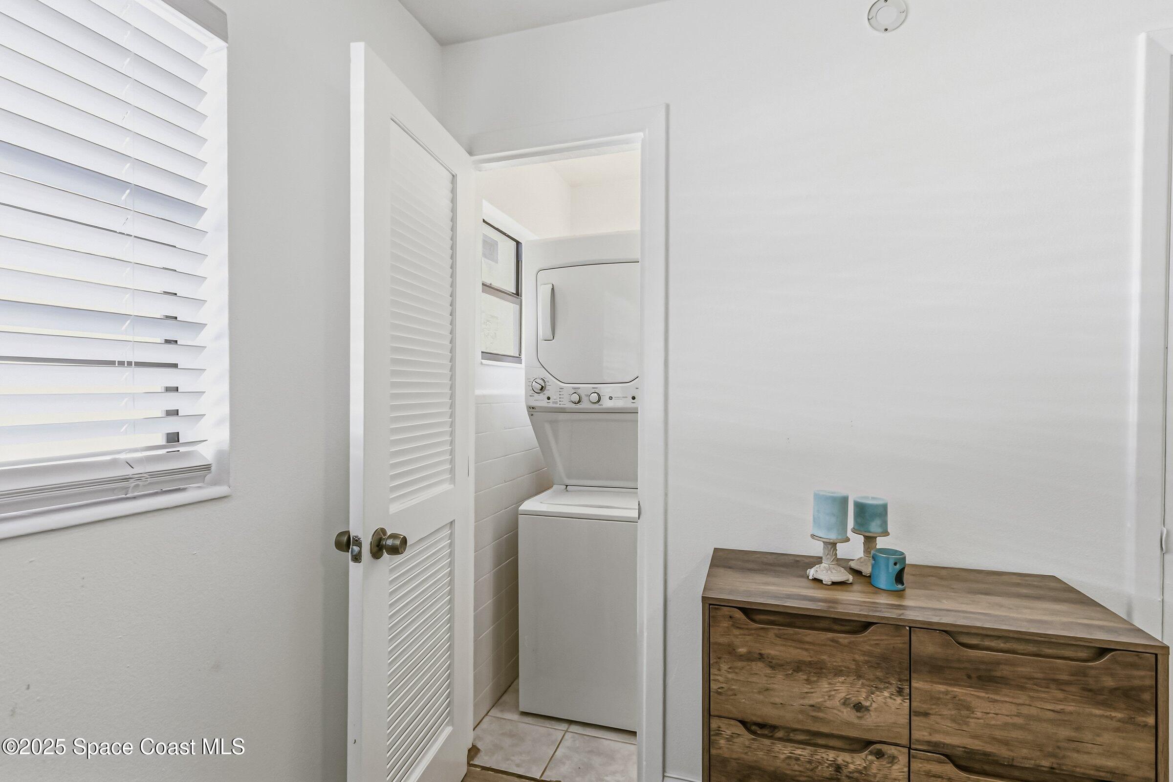 300 South Orlando Avenue, Unit 4 5 6 Cocoa Beach, FL 32931 - Photo 12 of 56 a bedroom with a bed and a mirror