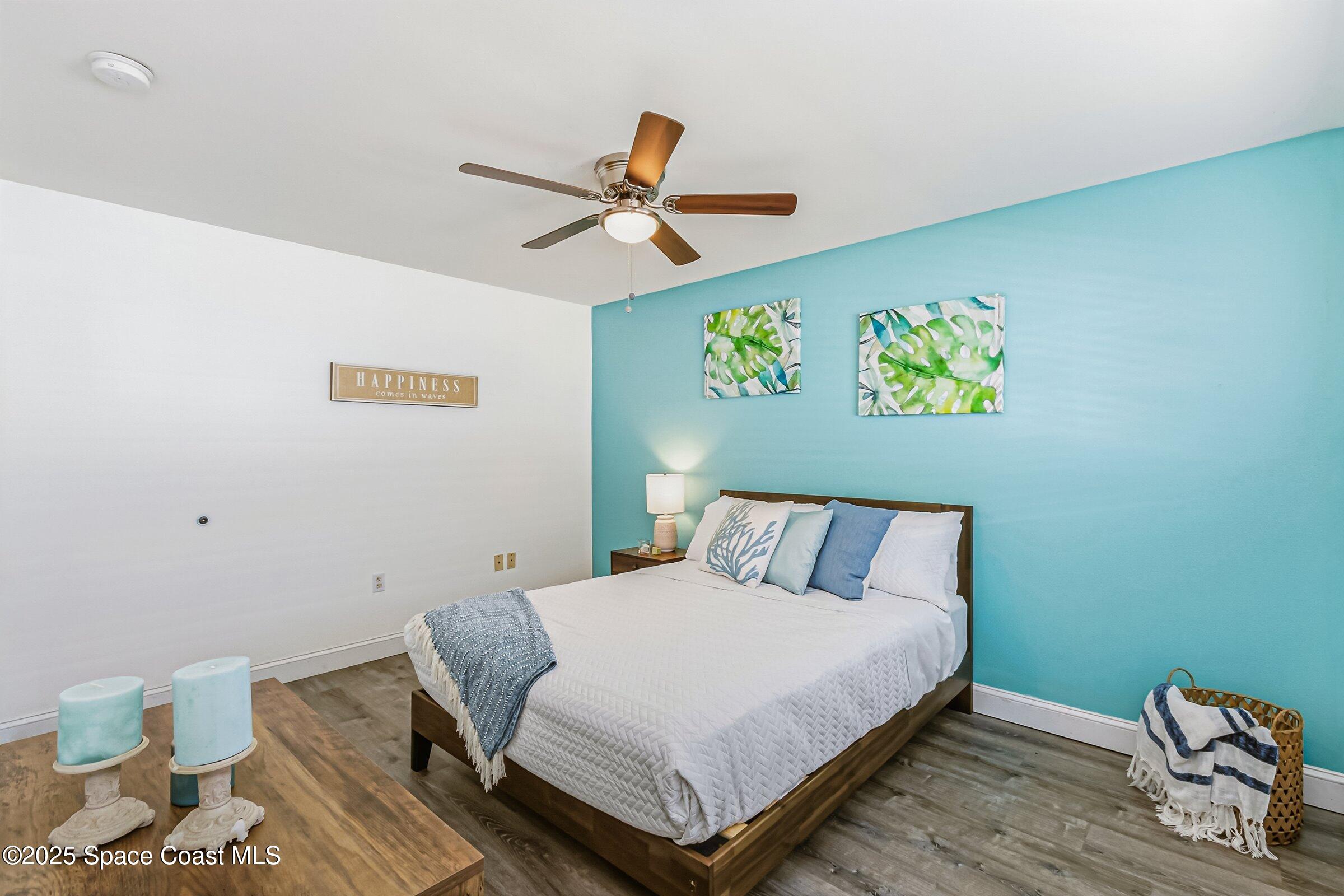 300 South Orlando Avenue, Unit 4 5 6 Cocoa Beach, FL 32931 - Photo 13 of 56 a bedroom with a bed and painting on the wall