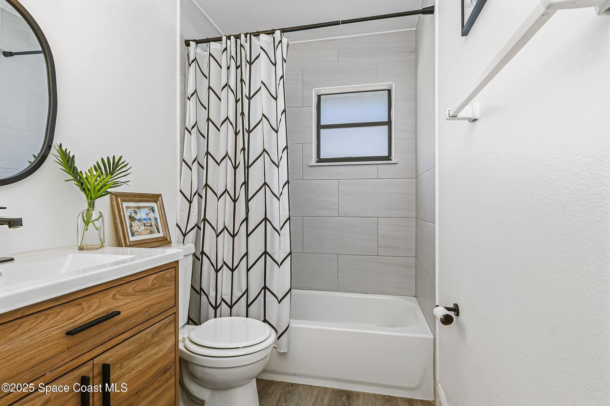 300 South Orlando Avenue, Unit 4 5 6 Cocoa Beach, FL 32931 - Photo 14 of 56 a bathroom with a toilet a sink and a bathtub