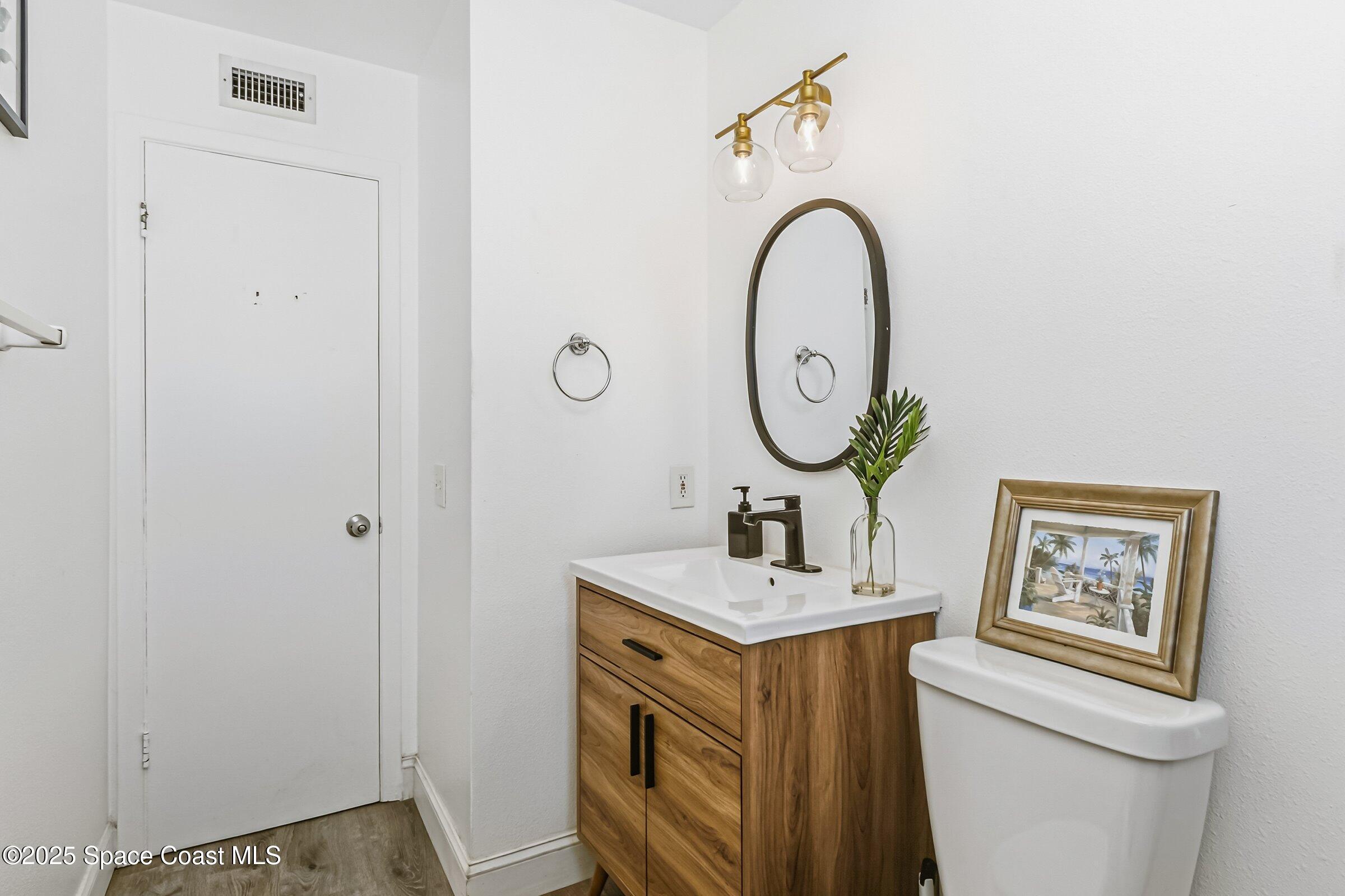 300 South Orlando Avenue, Unit 4 5 6 Cocoa Beach, FL 32931 - Photo 16 of 56 a bathroom with a sink and a mirror