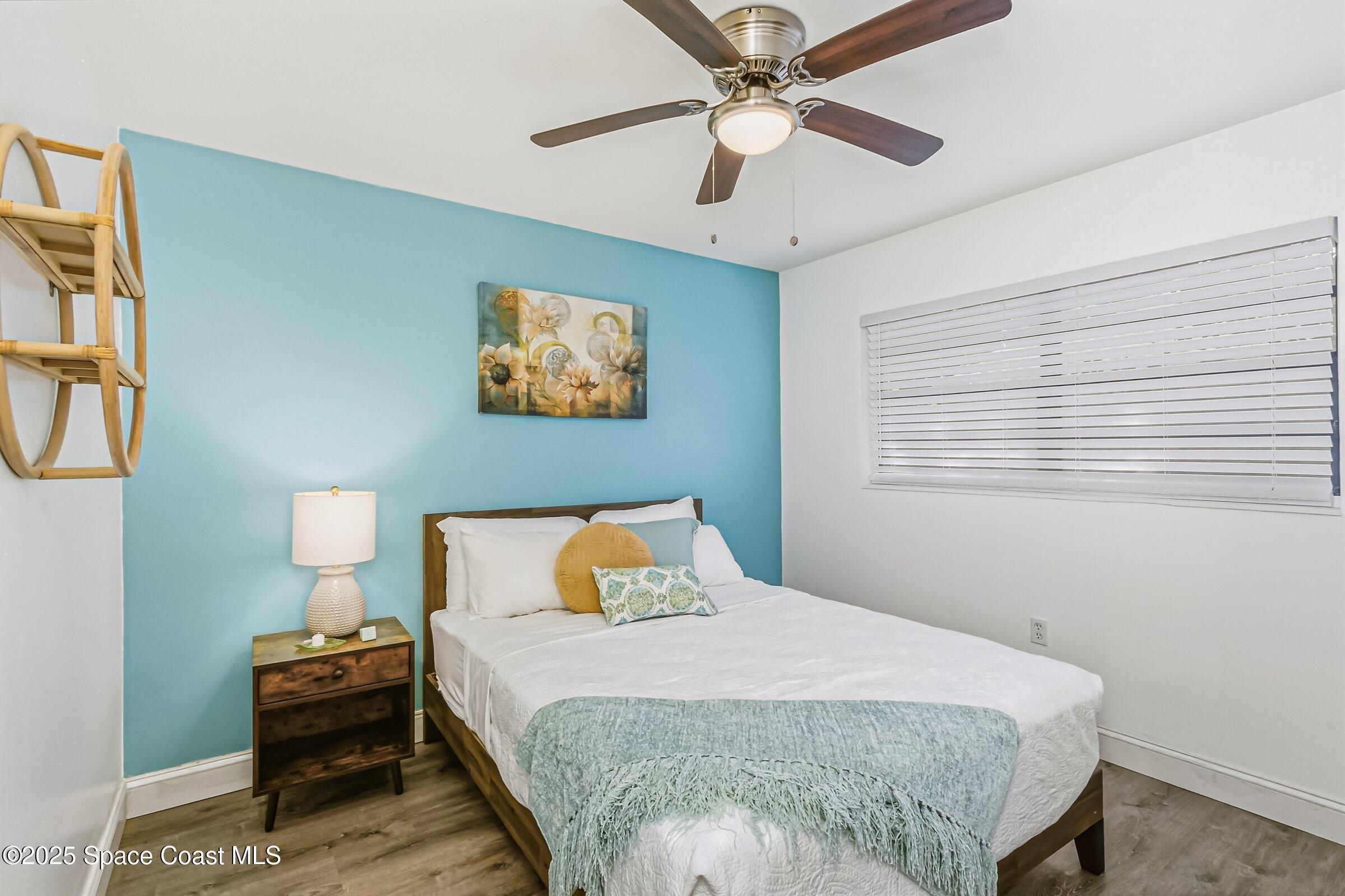 300 South Orlando Avenue, Unit 4 5 6 Cocoa Beach, FL 32931 - Photo 17 of 56 a bedroom with a bed and a chandelier