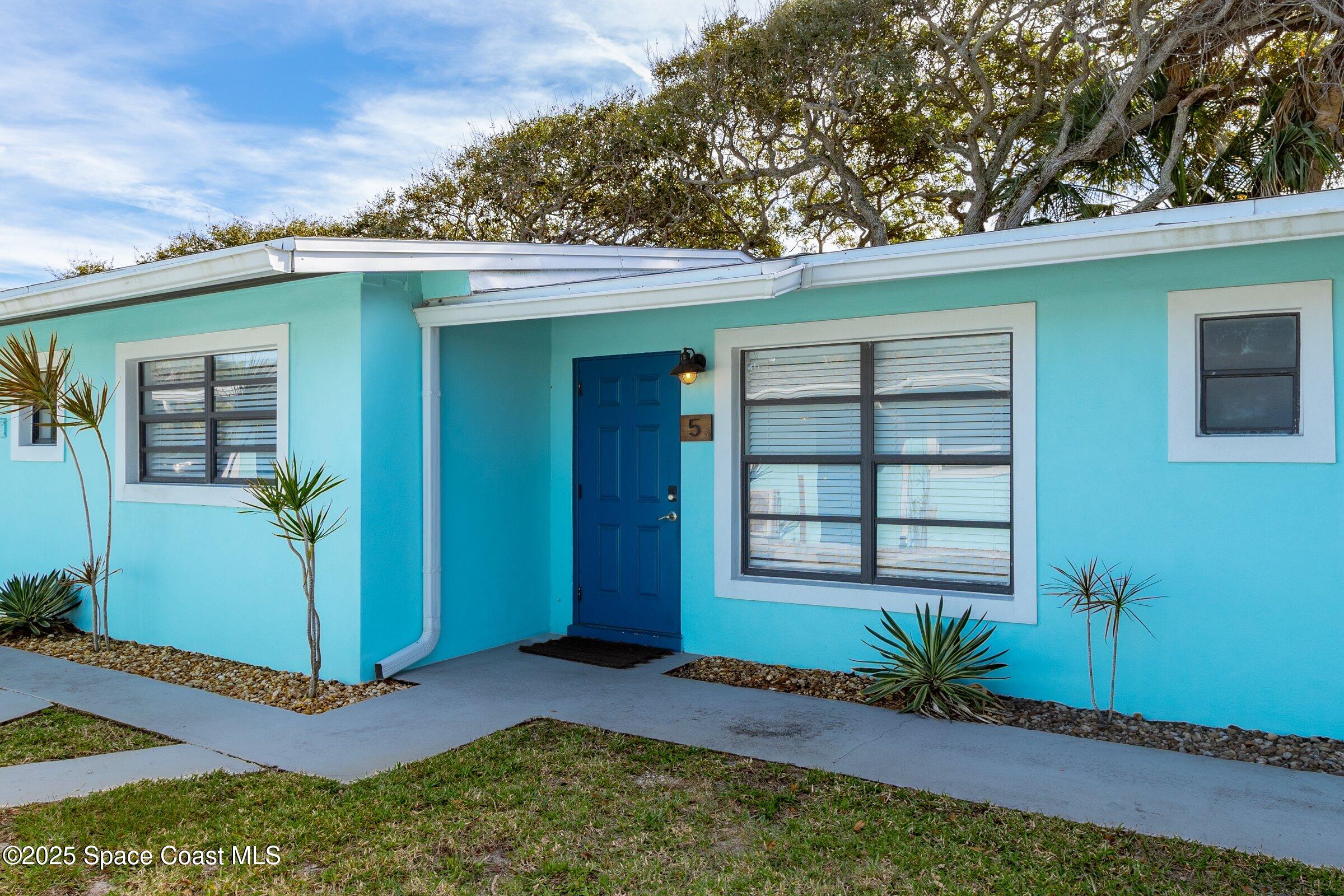 300 South Orlando Avenue, Unit 4 5 6 Cocoa Beach, FL 32931 - Photo 19 of 56 a front view of a house with a yard