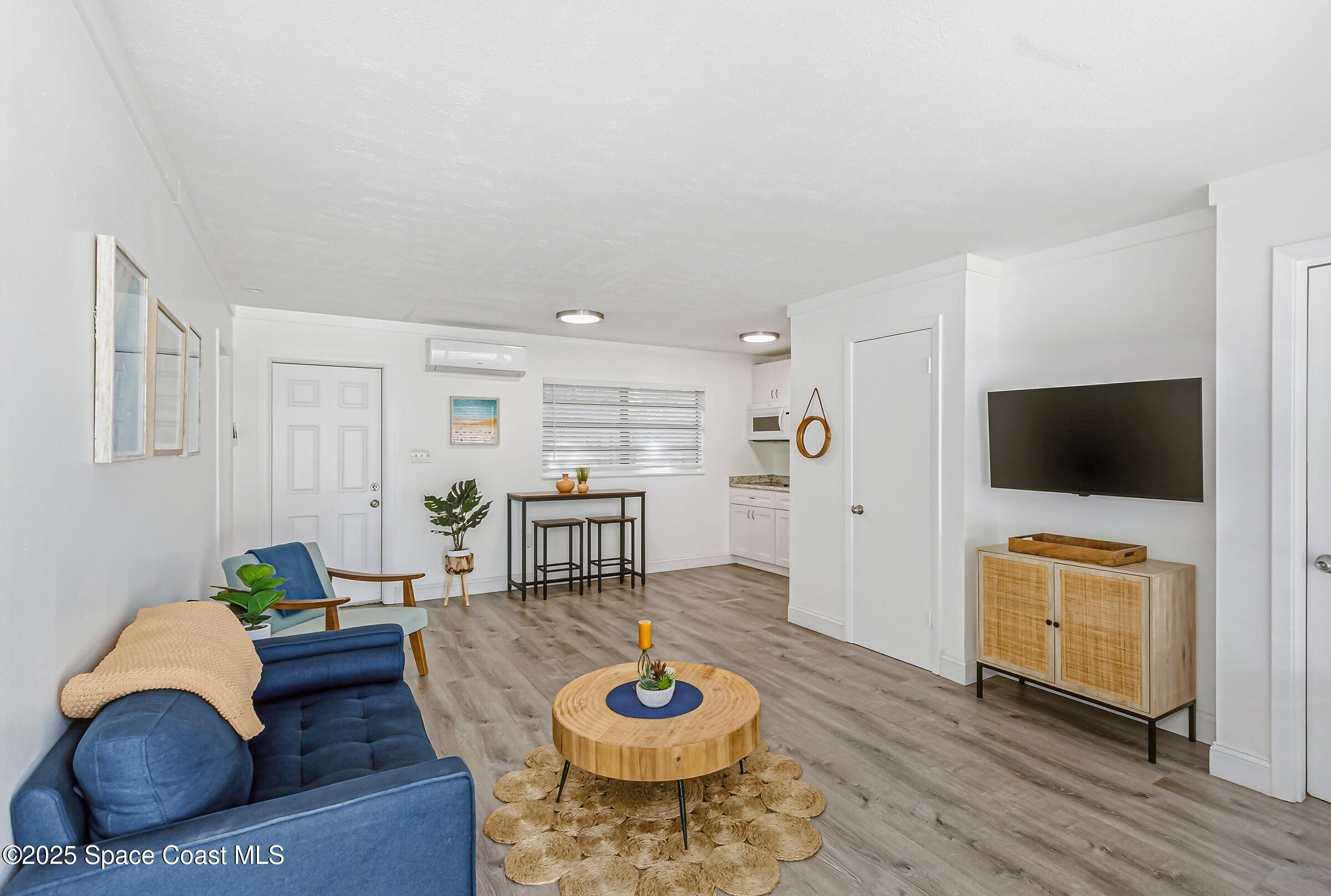 300 South Orlando Avenue, Unit 4 5 6 Cocoa Beach, FL 32931 - Photo 20 of 56 a living room with furniture and a flat screen tv