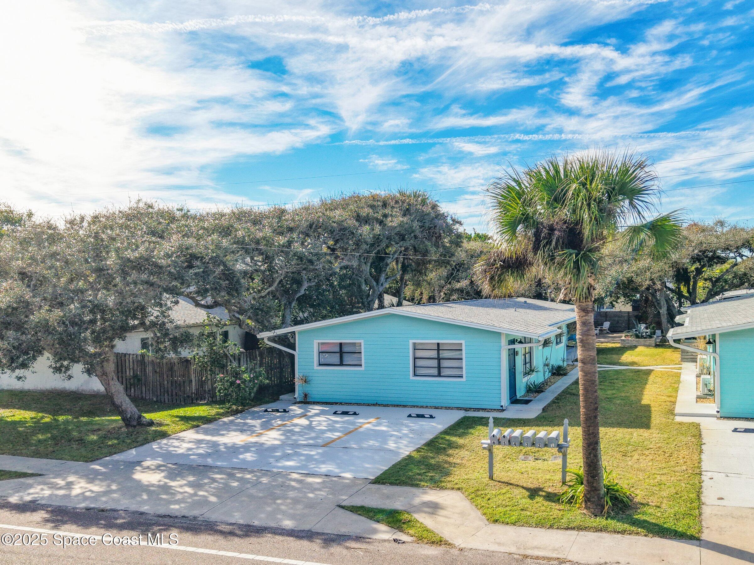 300 South Orlando Avenue, Unit 4 5 6 Cocoa Beach, FL 32931 - Photo 2 of 56 a view of a house with a yard