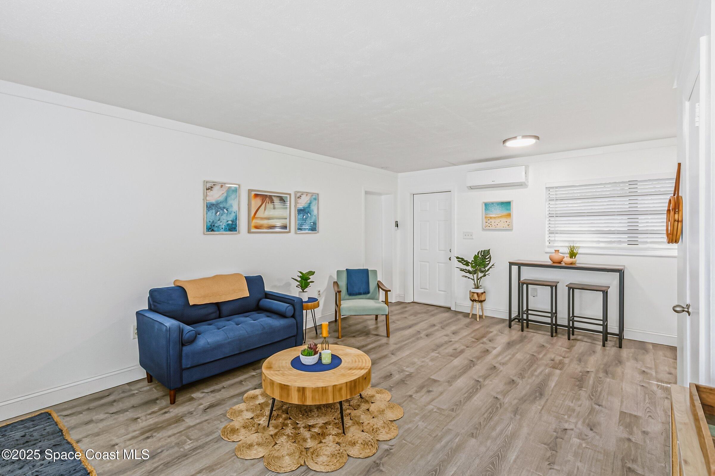 300 South Orlando Avenue, Unit 4 5 6 Cocoa Beach, FL 32931 - Photo 21 of 56 a living room with furniture and a wooden floor