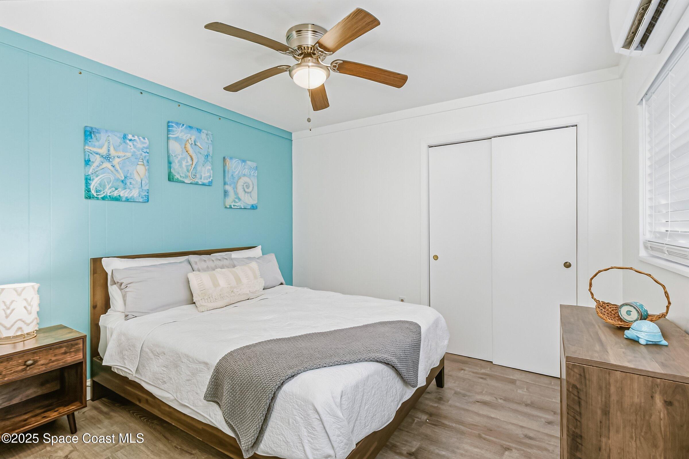 300 South Orlando Avenue, Unit 4 5 6 Cocoa Beach, FL 32931 - Photo 23 of 56 a bedroom with a bed and a chandelier
