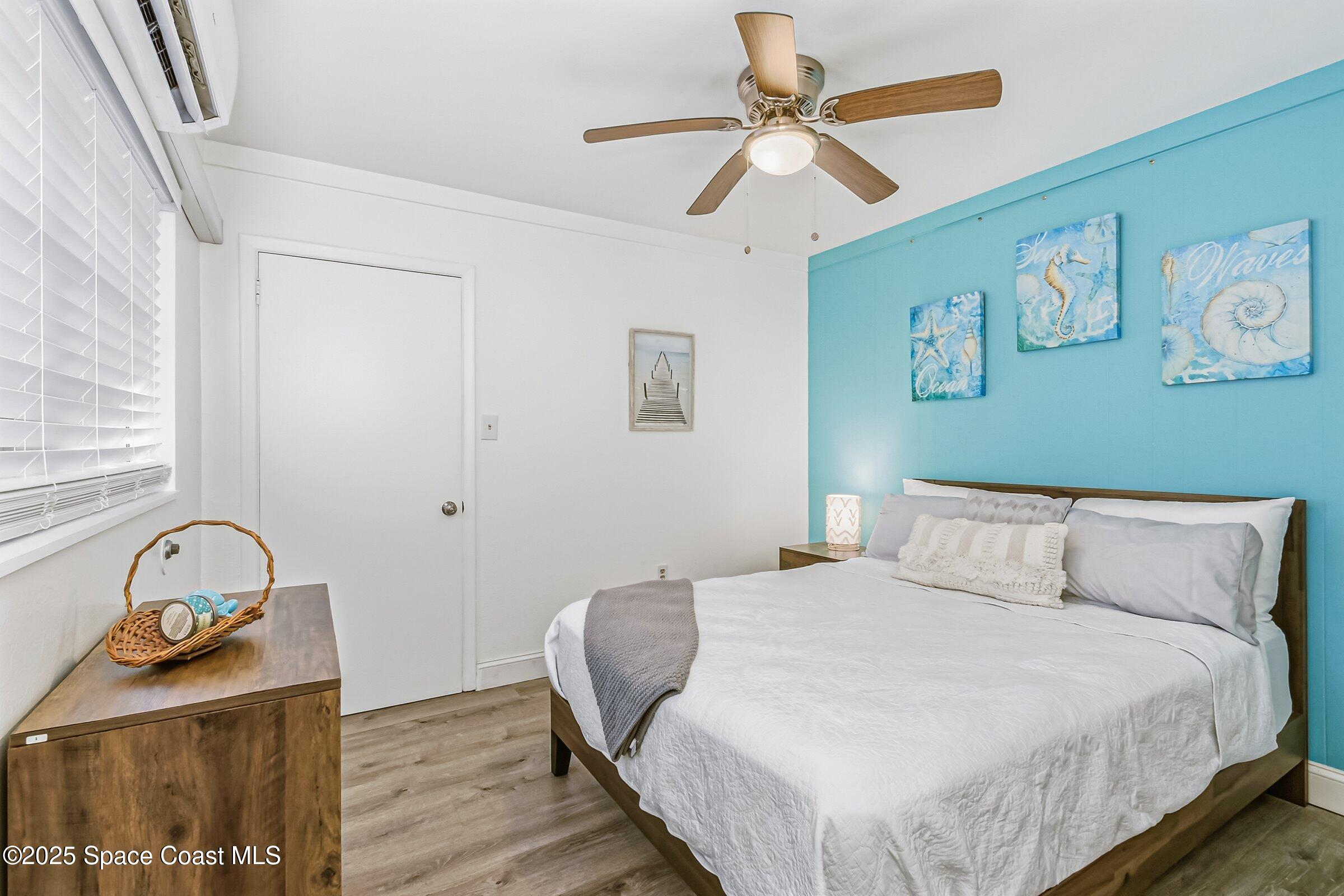 300 South Orlando Avenue, Unit 4 5 6 Cocoa Beach, FL 32931 - Photo 24 of 56 a bedroom with a bed and a ceiling fan