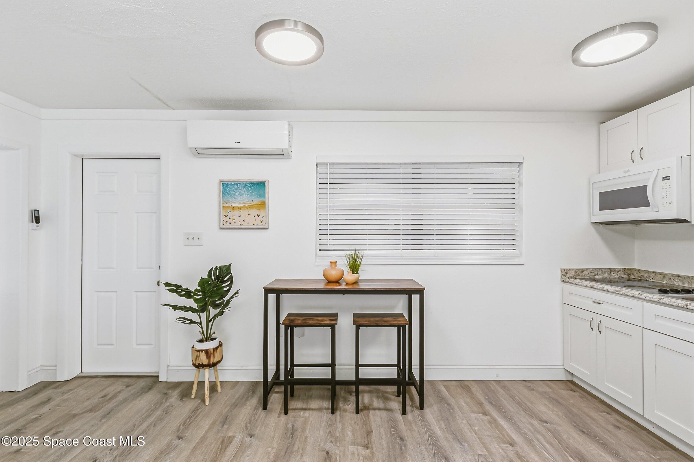 300 South Orlando Avenue, Unit 4 5 6 Cocoa Beach, FL 32931 - Photo 28 of 56 a view of kitchen with furniture and wooden floor