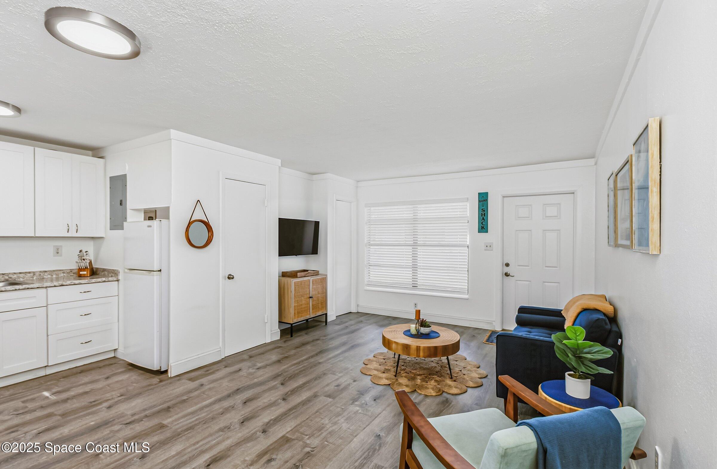 300 South Orlando Avenue, Unit 4 5 6 Cocoa Beach, FL 32931 - Photo 29 of 56 a living room with furniture and a table