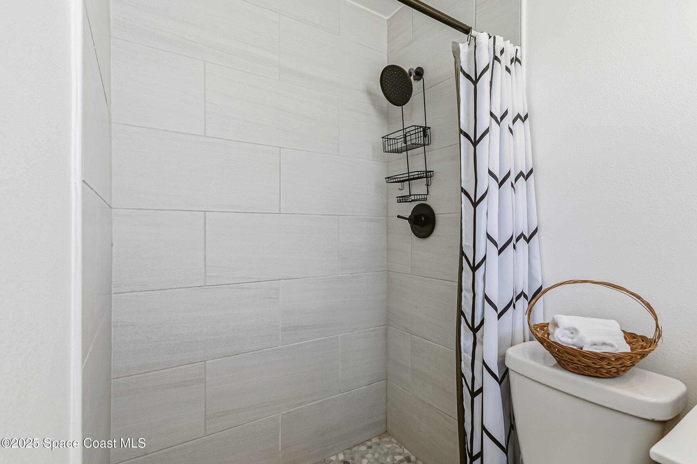 300 South Orlando Avenue, Unit 4 5 6 Cocoa Beach, FL 32931 - Photo 30 of 56 a bathroom with a toilet and a shower