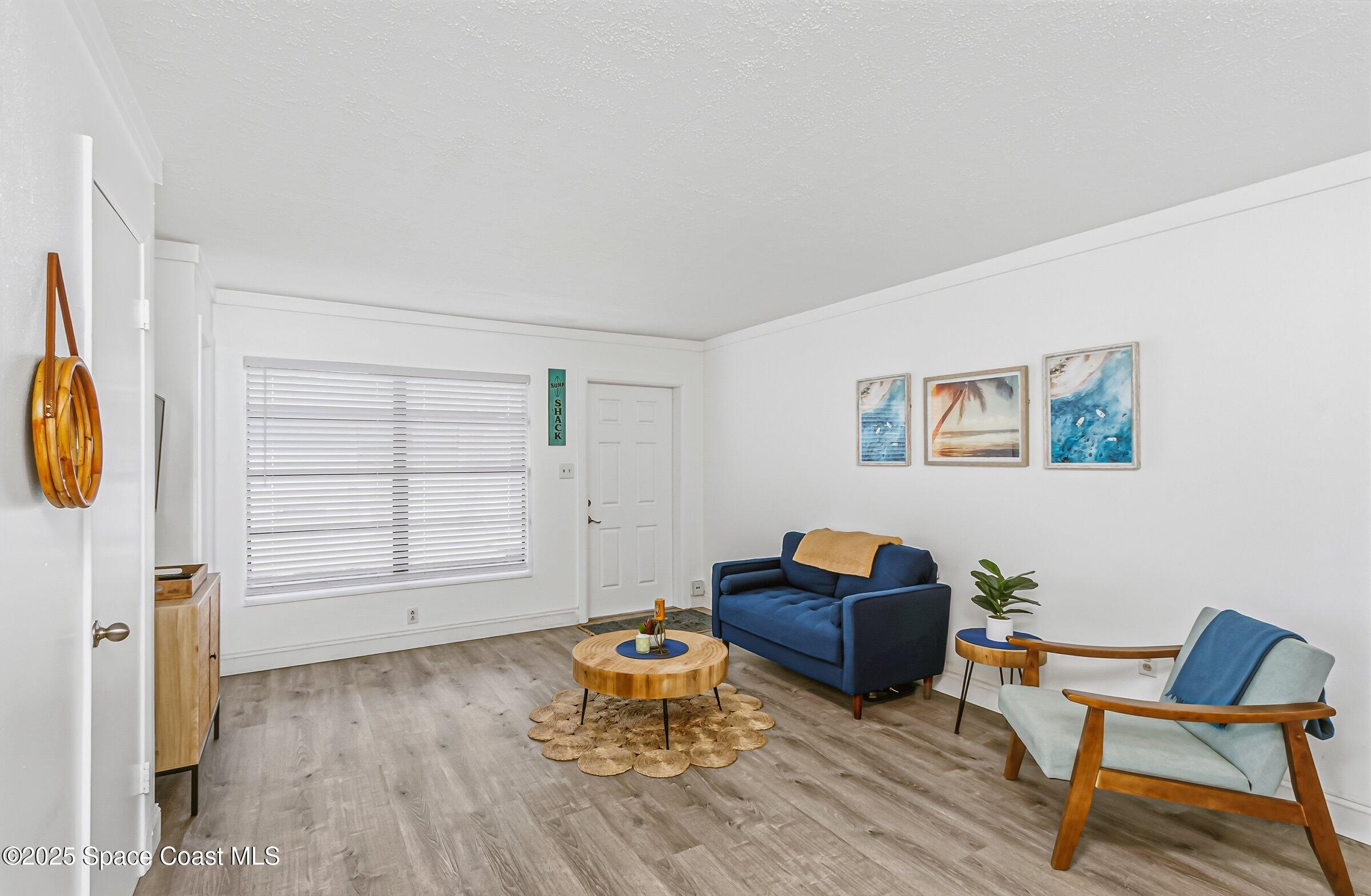 300 South Orlando Avenue, Unit 4 5 6 Cocoa Beach, FL 32931 - Photo 32 of 56 a living room with furniture and a wooden floor