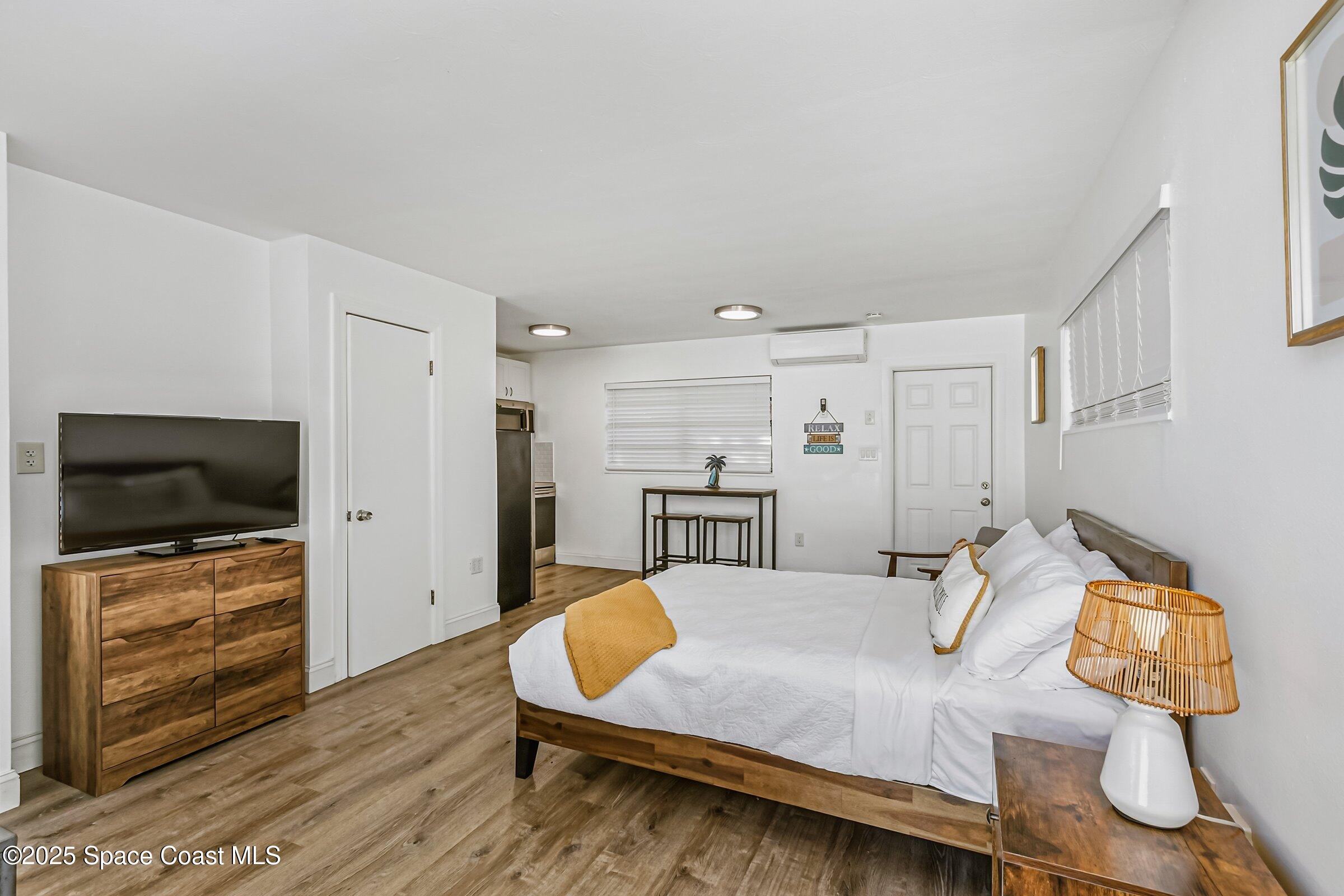 300 South Orlando Avenue, Unit 4 5 6 Cocoa Beach, FL 32931 - Photo 34 of 56 a living room with furniture and a flat screen tv