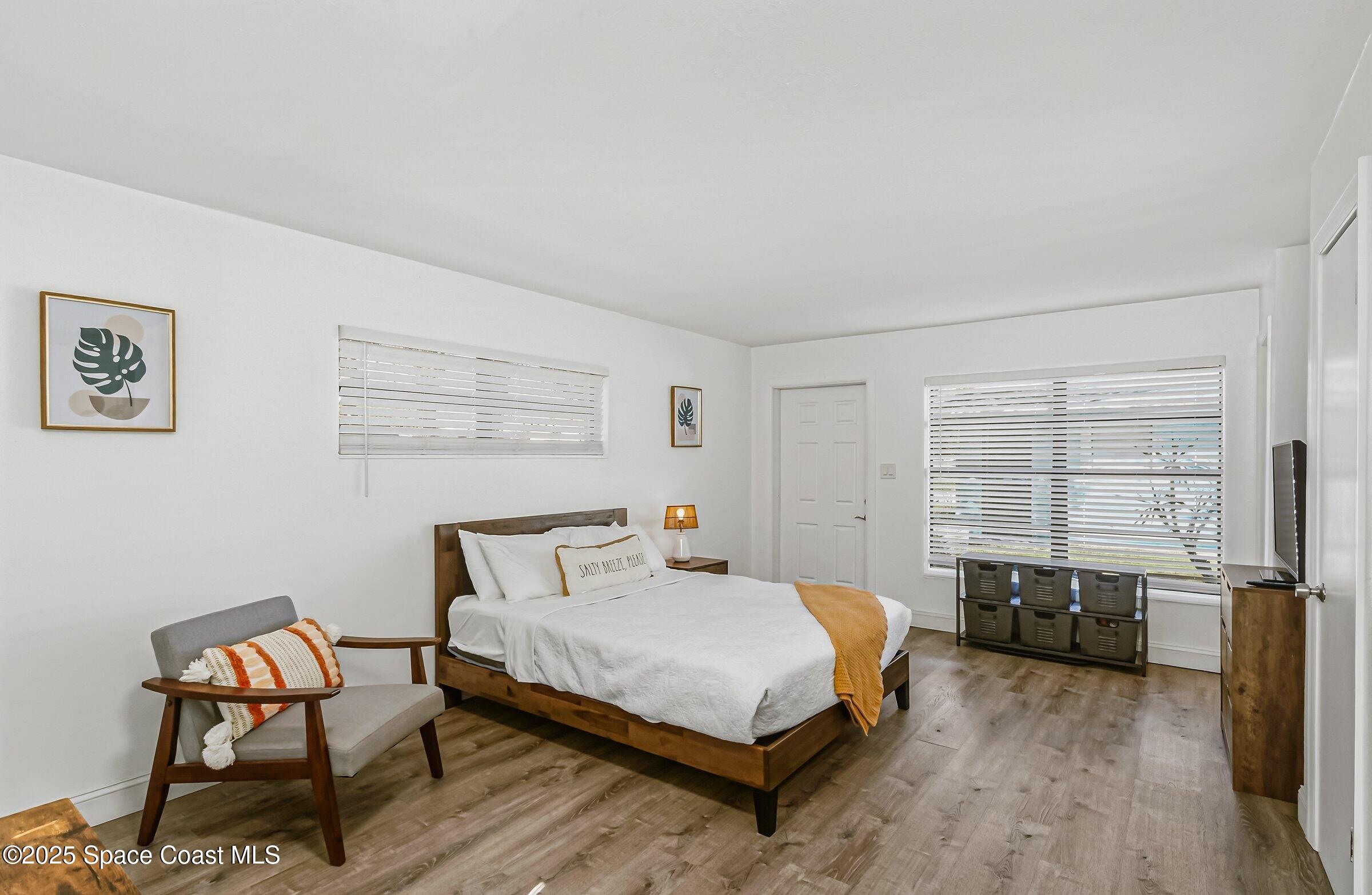 300 South Orlando Avenue, Unit 4 5 6 Cocoa Beach, FL 32931 - Photo 42 of 56 a bedroom with a bed and a window