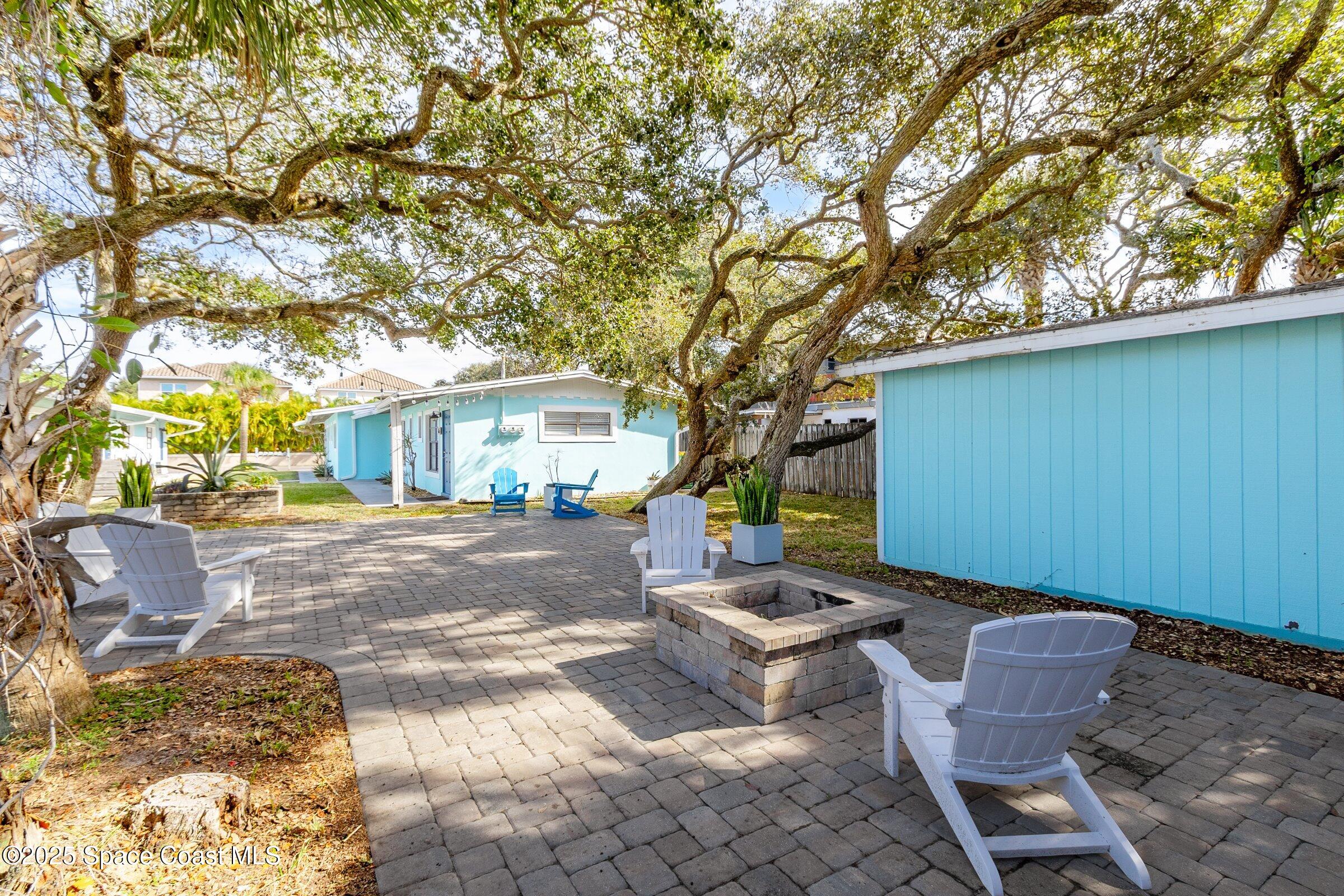300 South Orlando Avenue, Unit 4 5 6 Cocoa Beach, FL 32931 - Photo 46 of 56 a view of a patio with table and chairs and potted plants