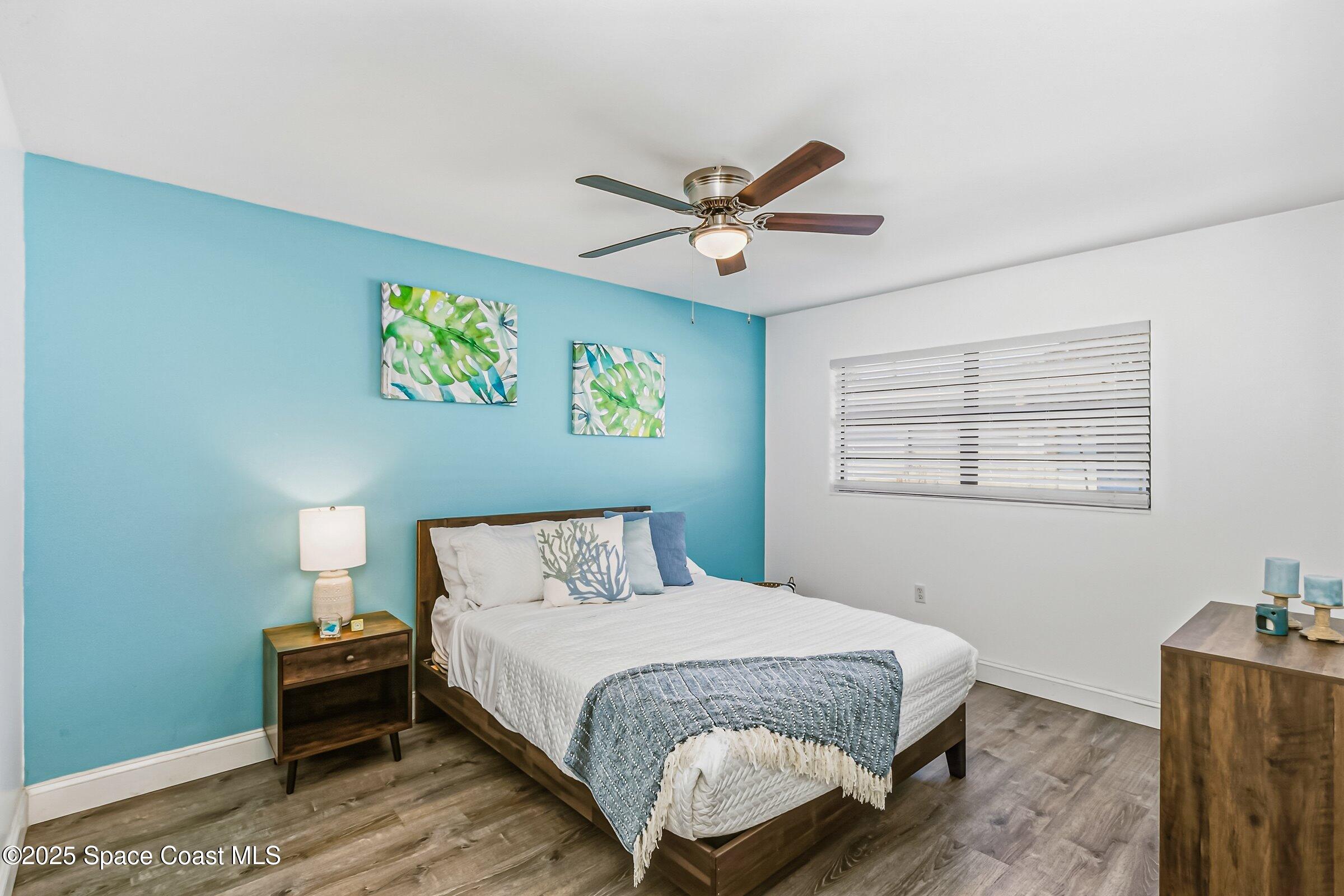 300 South Orlando Avenue, Unit 4 5 6 Cocoa Beach, FL 32931 - Photo 10 of 56 a bedroom with a bed and painting on the wall
