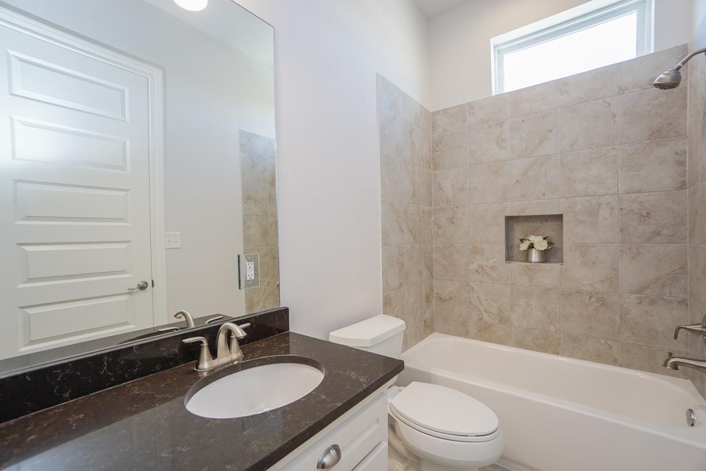 3351 Kilgore Street Houston, TX 77021 - Photo 12 of 25 a bathroom with a granite countertop sink toilet a mirror and bathtub