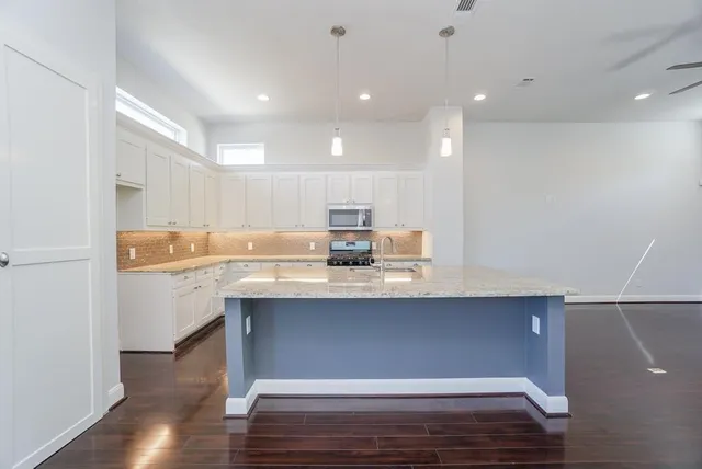 a kitchen with counter top space and cabinets