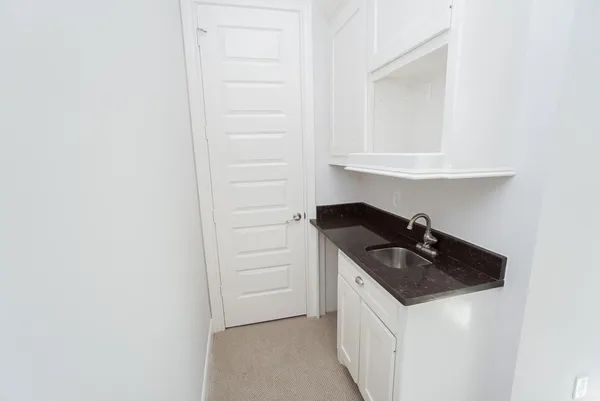 a kitchen with a sink and a refrigerator