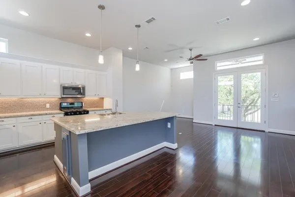 a kitchen with a sink window and cabinets