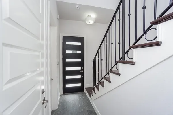 a view of entryway and hall with wooden floor