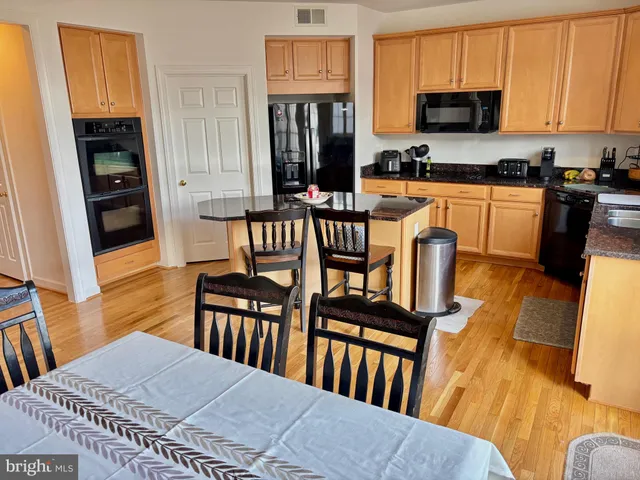 a view of kitchen with sink and wooden floor