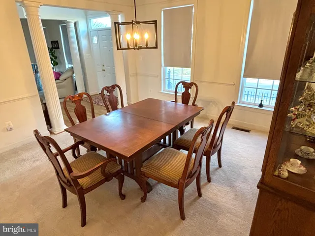 a view of a dining room with furniture and window