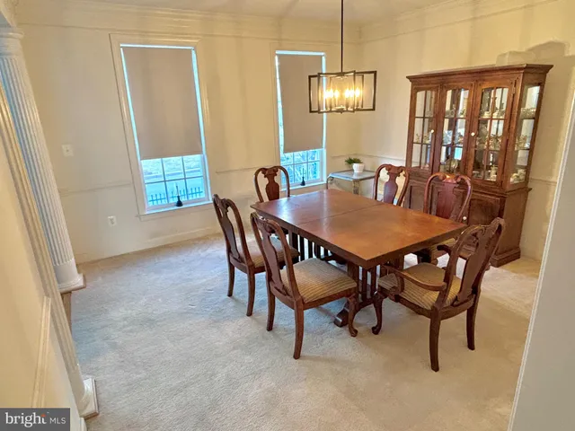 a view of a dining room with furniture and window