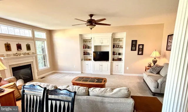 a living room with furniture fireplace and flat screen tv