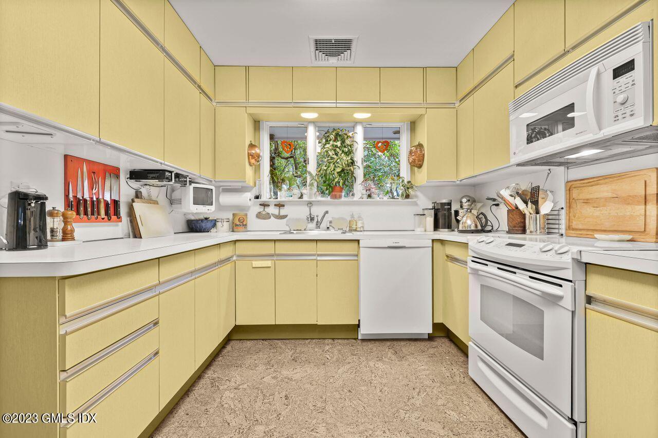 236 Riverside Avenue Riverside, CT 06878 - Photo 16 of 40 a kitchen with white cabinets and white appliances