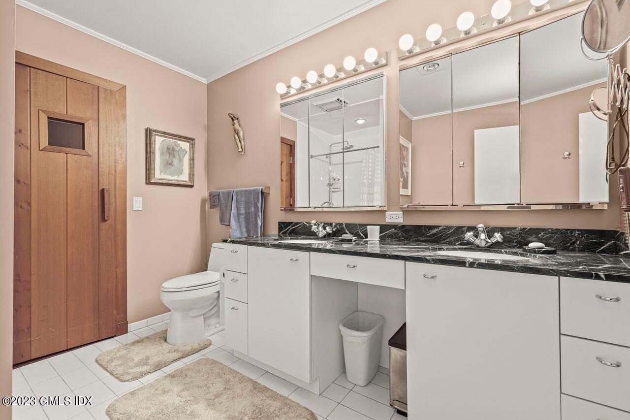 236 Riverside Avenue Riverside, CT 06878 - Photo 19 of 40 a bathroom with a sink a toilet and a mirror