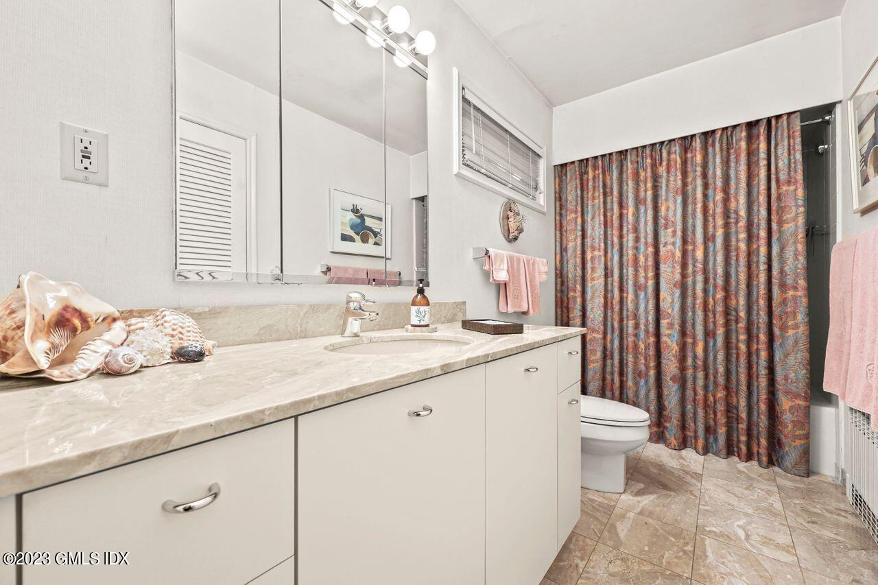 236 Riverside Avenue Riverside, CT 06878 - Photo 22 of 40 a bathroom with a granite countertop sink and a mirror