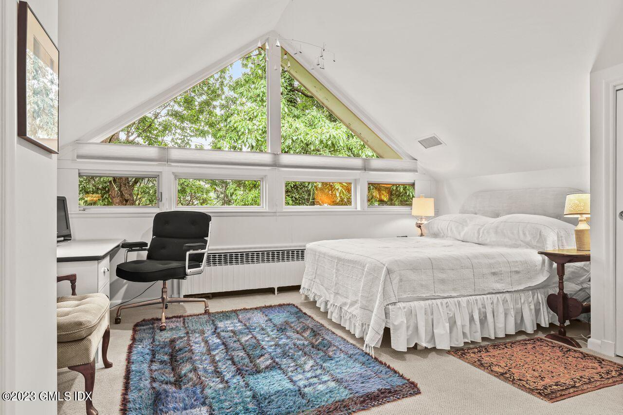 236 Riverside Avenue Riverside, CT 06878 - Photo 23 of 40 a bed room with a bed and a chair