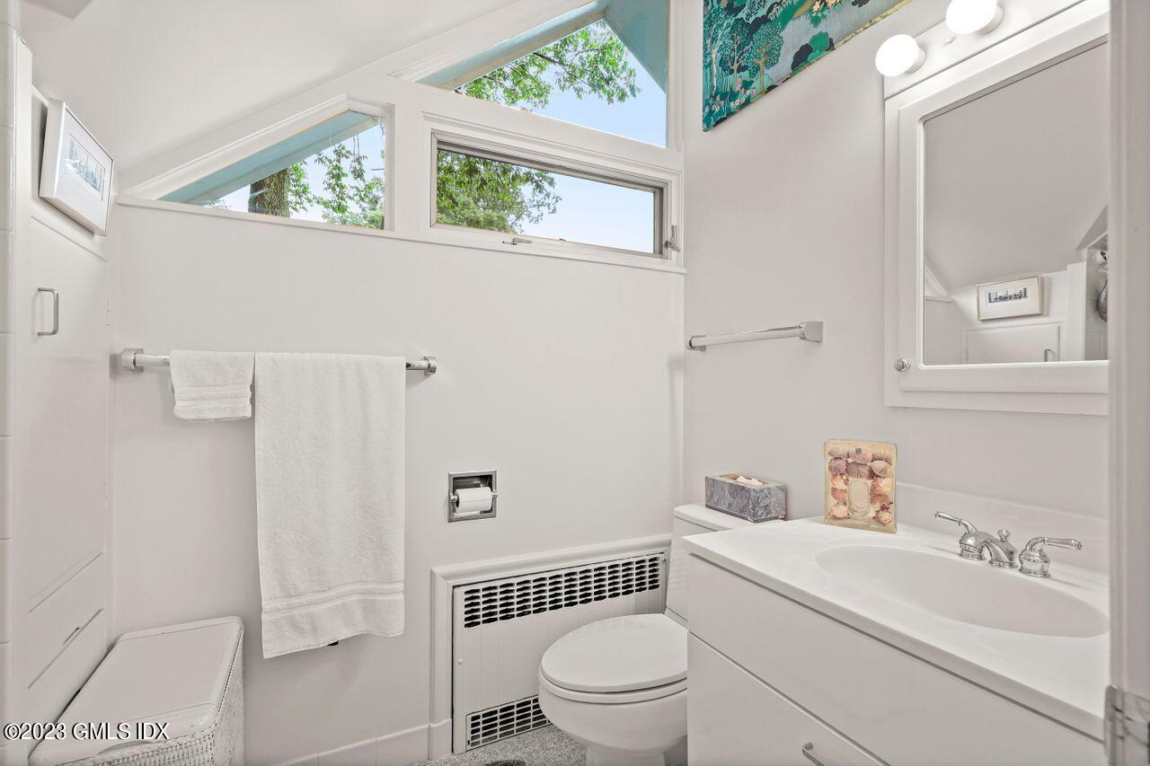 236 Riverside Avenue Riverside, CT 06878 - Photo 28 of 40 a white toilet sitting next to a bathroom sink