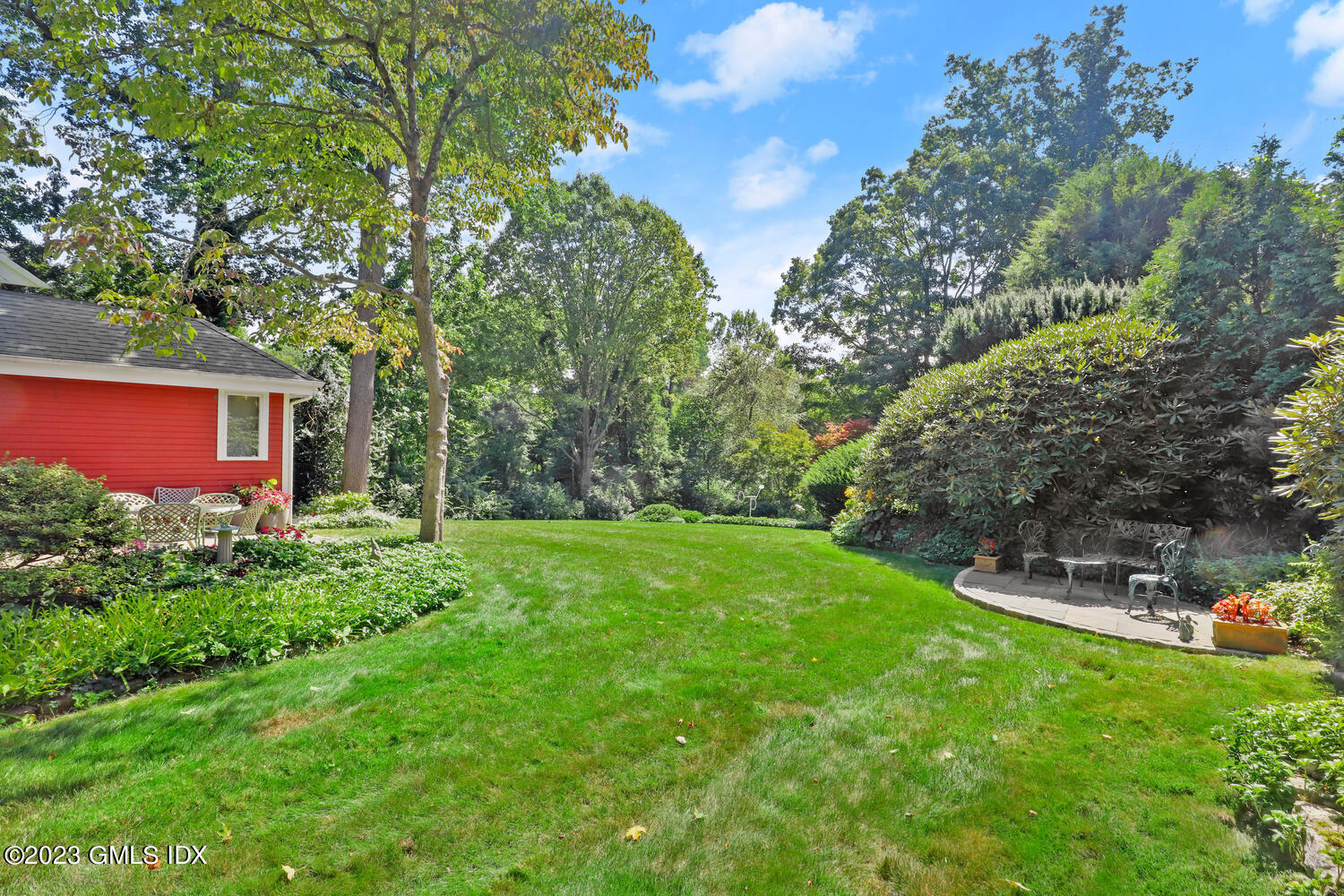 236 Riverside Avenue Riverside, CT 06878 - Photo 32 of 40 a view of a backyard with table and chairs and potted plants