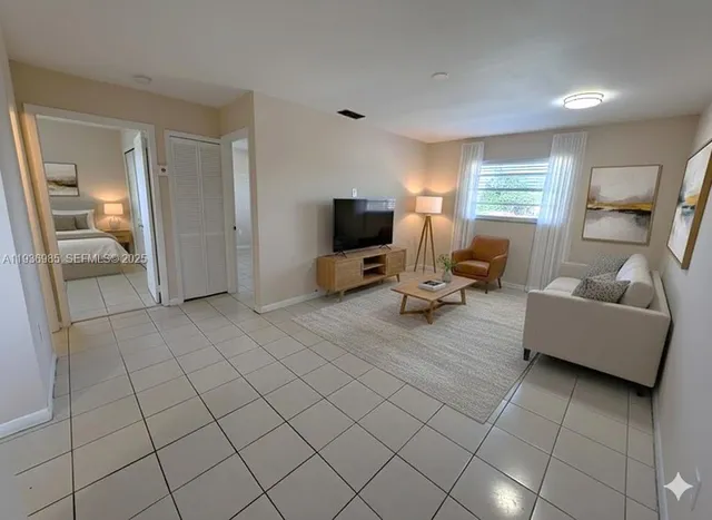 a living room with furniture and a flat screen tv