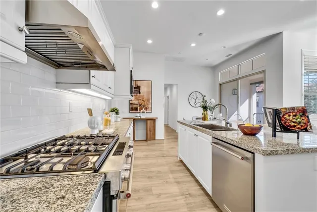 a kitchen with sink stove and cabinets
