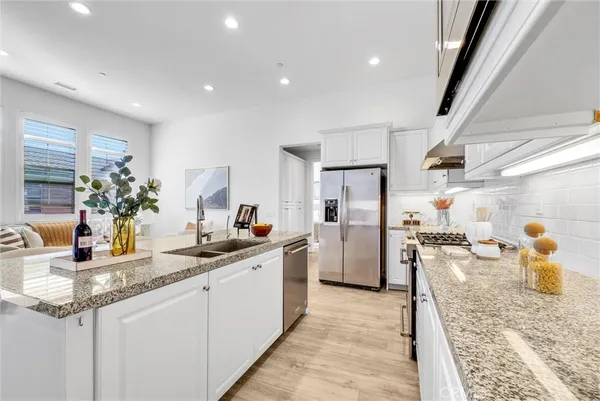 a kitchen with a sink dishwasher stove and refrigerator