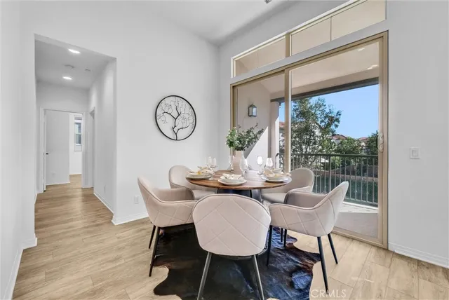 a dining room with furniture wooden floor and a rug