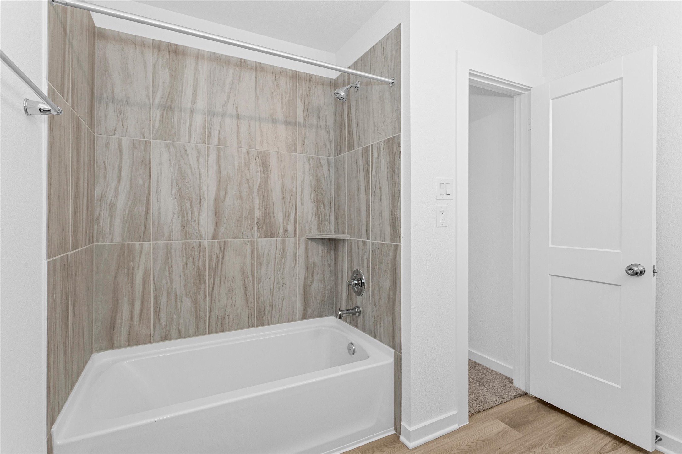 2127 Heather Rdg Way Rosenberg, TX 77471 - Photo 33 of 41 This upstairs full bathroom features a tub and shower combination with stylish tile surround, offering a clean, modern space that has never been used.